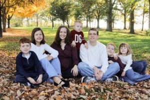 Family sitting in leaves